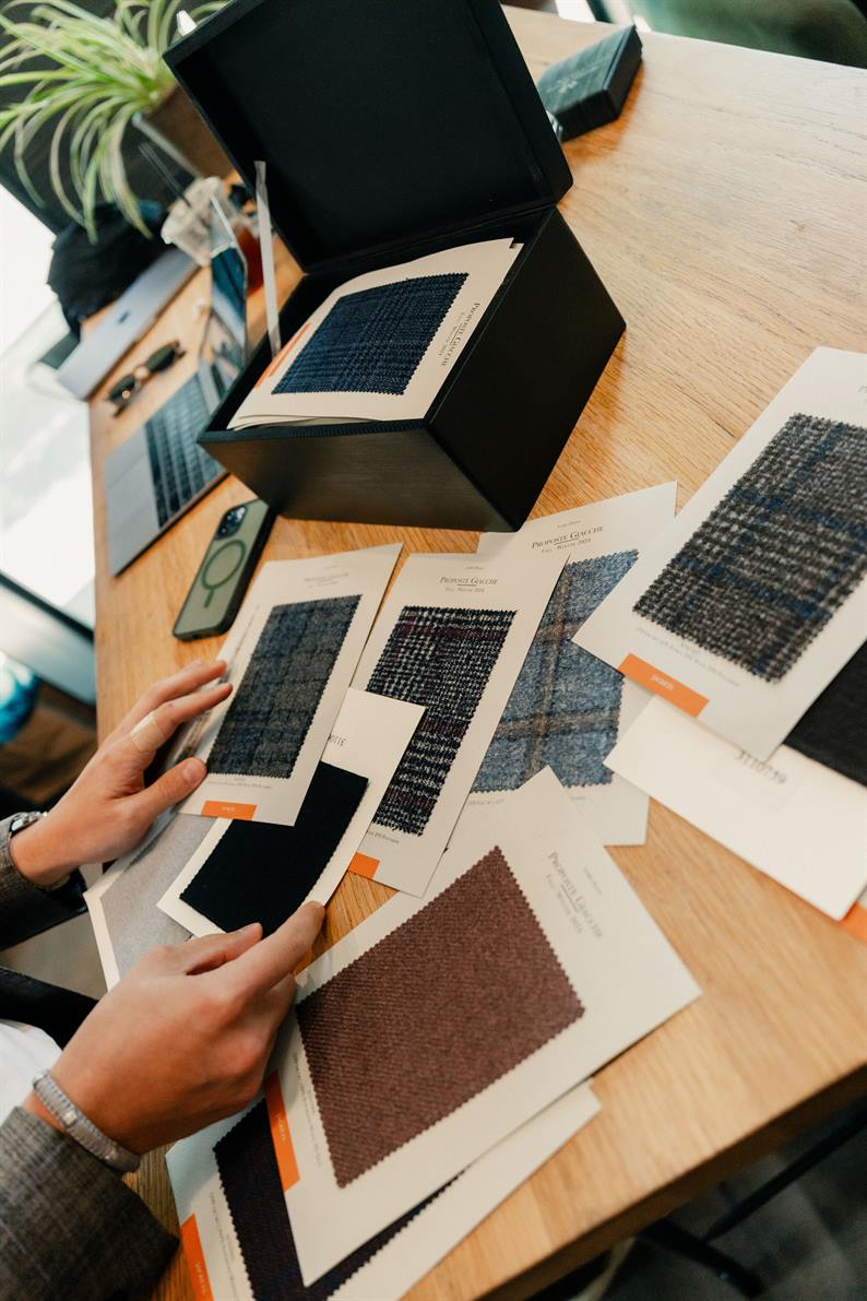 Client selecting fabric swatches for a custom wedding garment